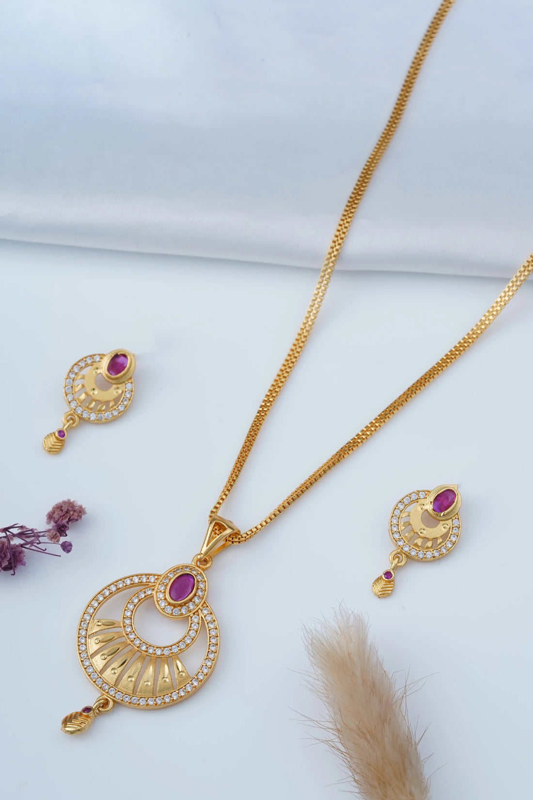 TooBela gold tone temple style pendant necklace set with pink oval stone and crystal detailing