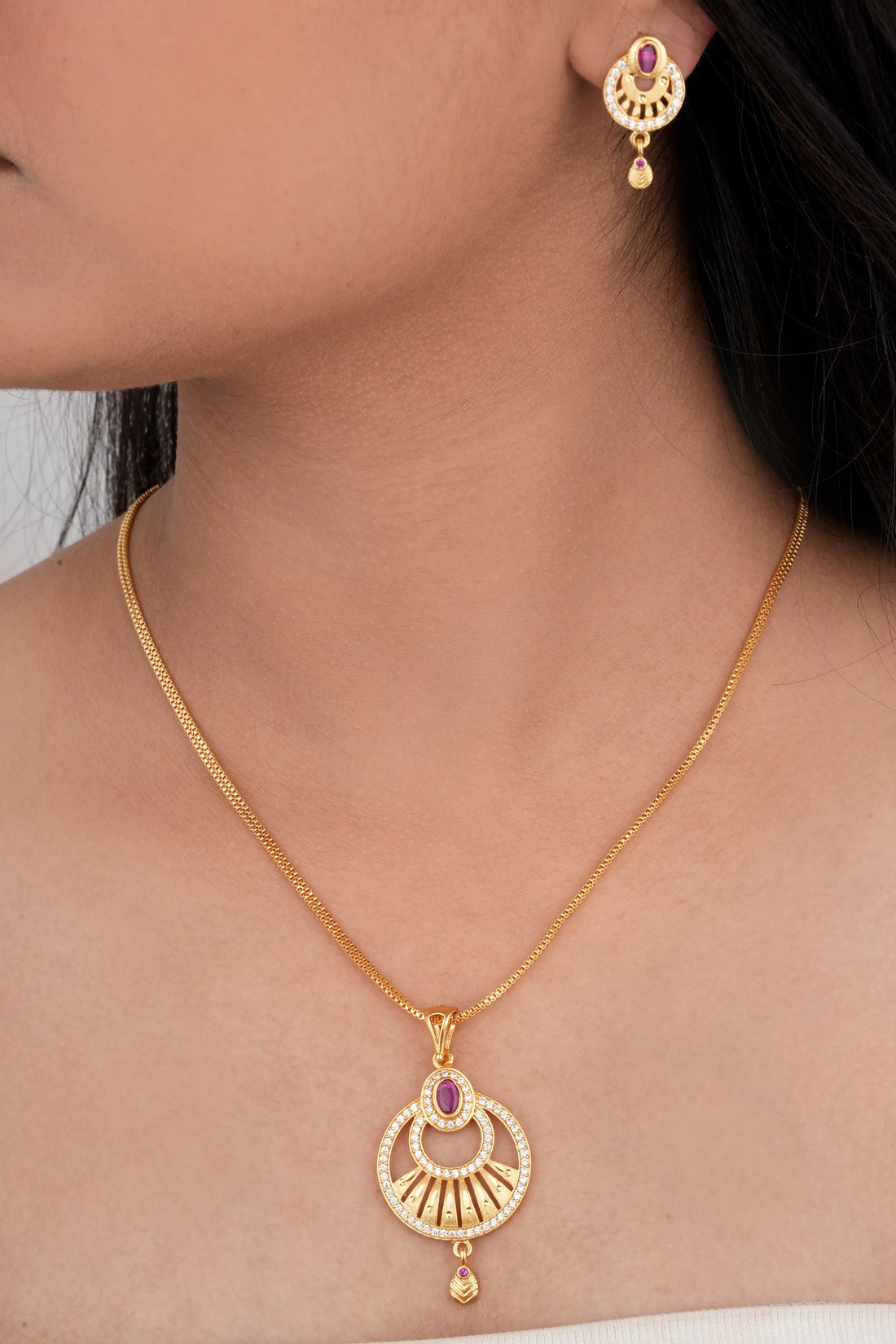 TooBela gold tone temple style pendant necklace set with pink oval stone and crystal detailing